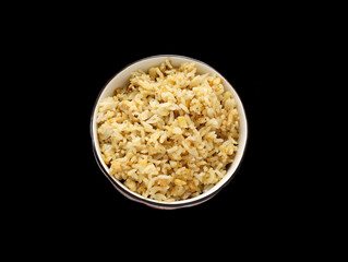 A bowl of Chinese egg fried rice on a black background