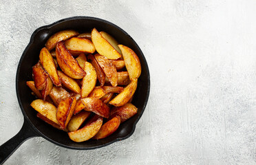 fried potato slices, in a cast-iron pan, homemade, no people,