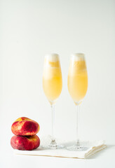 Summer refreshing fruit cocktail bellini of fresh ripe peach and prosecco in glasses