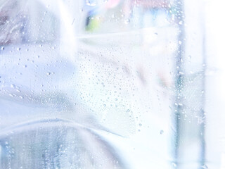 Blurred background image of water vapor clinging to the glass wall.