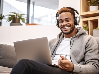 Man Working On Laptop With Headphones