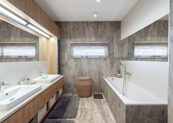 Bright Elegant Modern Bathroom Interior Design of White Bath, Sink, Mirror. Bathroom Accessories, Gray Tile Walls, LED Light.