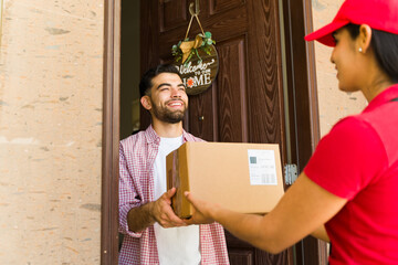 Customer joyfully accepting a delivery from a female courier at his doorstep