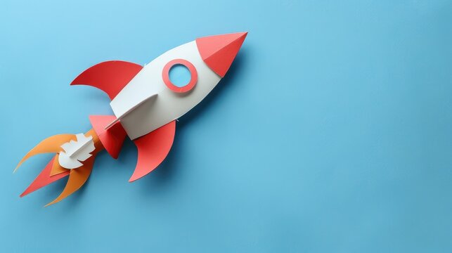 Rocket paper craft taking off with copy space on a blue background symbolizing back to school