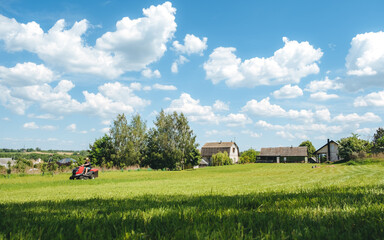 Man on lawn tractor mowing lawn on backyard. The red rider. The lawnmower tractor. High quality 4k footage