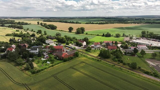 Flight towards Hadmersleben in summer. Train stops at the station of Hadmersleben, a district of Oschersleben (Bode). Boerde landscape in the north of Saxony-Anhalt.