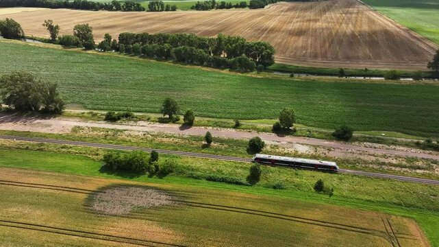 Train travels towards Magdeburg. Railway line from Lower Saxony to Saxony-Anhalt. Agriculture in the Boerde region in the north of Saxony-Anhalt. Large agricultural cooperatives in central Germany.