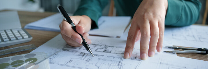 Architects interior designer hands working with Blue prints and documents for a home renovation for house design