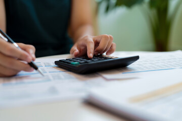 Fototapeta premium Female calculating personal financial for future plan at her home, taxes payment..