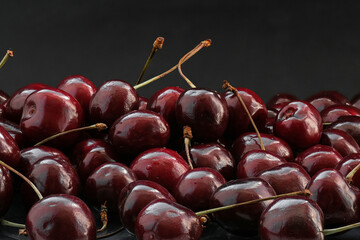 ripe cherries on a black background