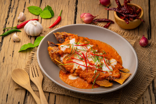 Fried Red Tilapia Fish with red curry sauce,Thai Choo Chee Fish Curry in a plate