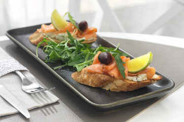 Bruschetta with salmon. Whole grain bread with salmon, cheese and a slice of lemon