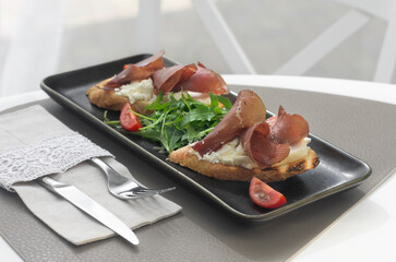Bruschetta with prosciutto . Italian cuisine. National food