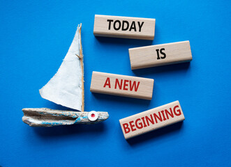 Today is a new beginning symbol. Wooden blocks with words Today is a new beginning. Beautiful blue...