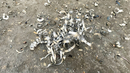 Scrap metal shavings strewn across the iron factory floor