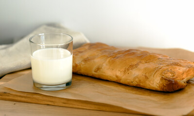 sweet home made pastry bakery made from puff pastry with a crispy crust and a glass of milk. homemade hot cakes