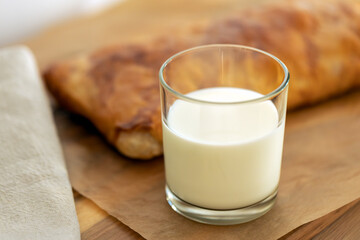 sweet home made pastry bakery made from puff pastry with a crispy crust and a glass of milk. homemade hot cakes