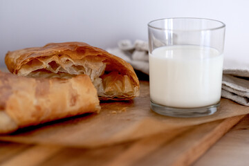 sweet home made pastry bakery made from puff pastry with a crispy crust and a glass of milk. homemade hot cakes