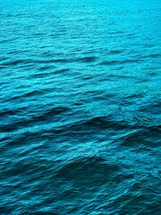 A serene close up of the rippling blue surface of water