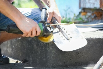 a man works with a grinder