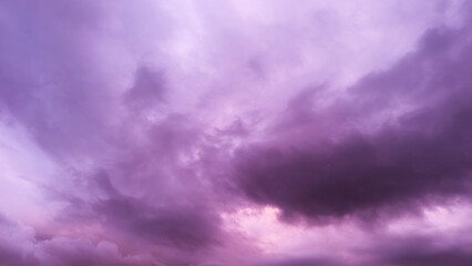 A pink and purple sky at sunset, German village and trees