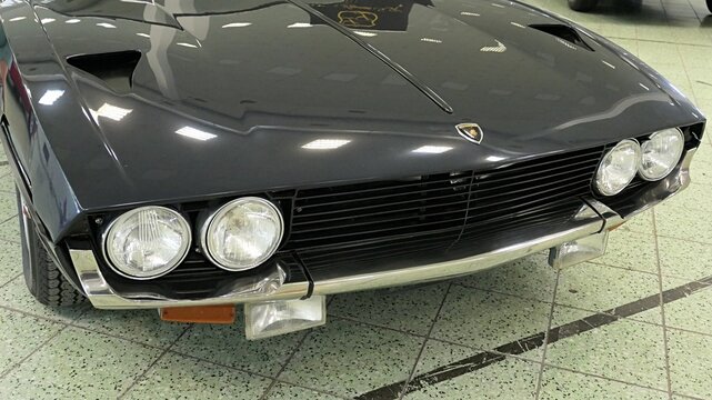 Right front view of front mask of four seat italian grand touring coupe car  of Lamborhini Espada from year 1968, black color, displaye on car and tuning show in Nitra, Slovakia, june 2024