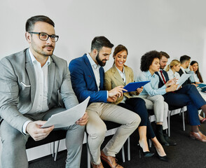 man business chair sitting waiting businessman candidate recruitment office businesswoman woman businessperson job young interview line employee career row hall colleague