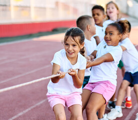 child sport exercise athlete rope competition strength challenge teamwork effort pulling pull tug...