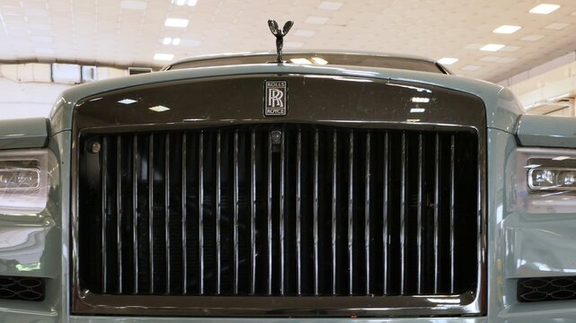 Front mask detail of modern luxurious british SUV car Rolls Royce Cullinan with typical RR logo and Spirit Of Ecstasy statue. Displayed on car and tuning expo in Nitra, Slovakia. 