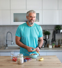 kitchen food man healthy morning mature breakfast active fitness diet home healthy senior adult  lifestyle fruit sport fit health eating preparation nutrition middle aged