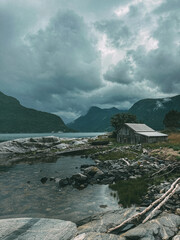Gloomy Norway hut in front of fjords in July