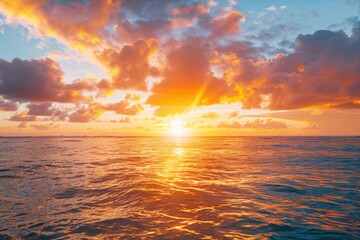 A serene sunset scene with clouds covering half of the sky, overlooking the calm ocean
