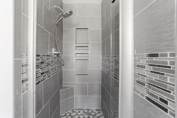 Modern Grey Tiled Shower With Built-In Shelves And Metallic Showerhead