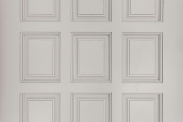 White Paneled Door With Rectangular Patterns Creating A Textured Surface