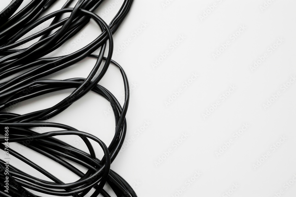 Poster A close-up image of multiple black wires lying flat on a white surface, often used as a symbol for technology, coding, or electronics