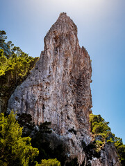 Monolithic Es Penyal Bernat geological limestone formation under sunny sky, ideal for educational purposes, illustrating natural erosion and geological landmarks for academic and environmental studies