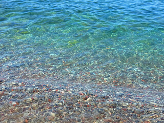 Blue sea waves on pebble beach