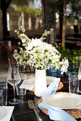 Wedding Tablescape with White Baby Breath Flowers, Blue napkins, and Boho theme