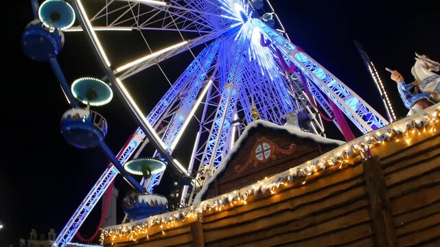 Ferris Wheel in Christmas Village at night : the festive atmosphere in Lille Main Square, France