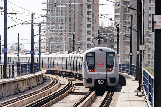 Delhi metro and the metro station. Metro rail in delhi. Dmrc metro entering the station.  Indian Subway Train.