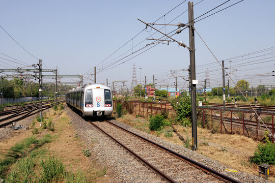 Delhi metro and the metro station. Metro rail in delhi. Dmrc metro entering the station. Indian Subway train.