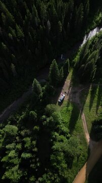 Vertical top down aerial of camper in St Joe Mountains camping along creek in north Idaho