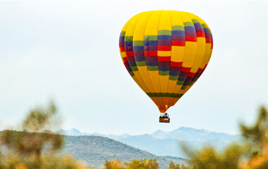 Obraz premium Sunrise Hot Air Balloon Rising In The Fog