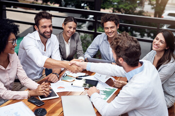 Cafe, business people and shaking hands for teamwork, success and partnership in finance project....
