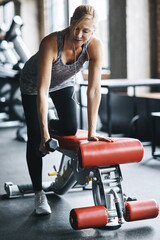 Woman, exercise and dumbbells with music in gym for muscle strength, audio streaming and training....