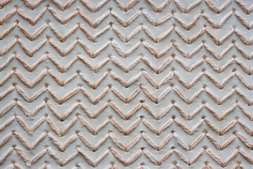 Textured chevron pattern created with natural beige fibers.This design offers a tactile, handcrafted feel, ideal for themes related to textiles, interior design, and natural materials.