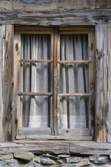 A window with a curtain hanging on a stone wall, possibly old and worn out