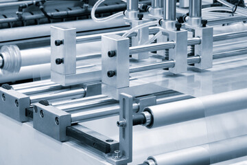 Automatic polyethylene plastic bag production machine with lighting effect. Close-up of the roller...