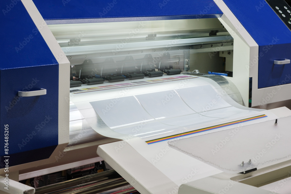 Poster a machine is printing a piece of paper. the paper is white and has a rainbow design on it