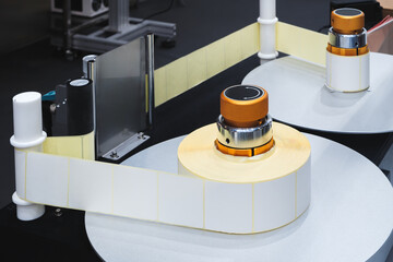 A roll of white paper is passed through the machine. printer and sticker machine, which is used for...